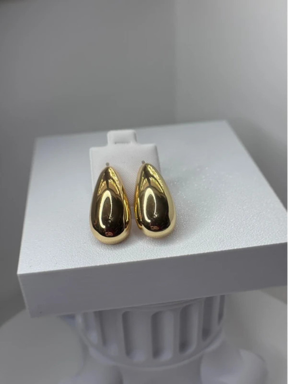 Gold tone clip on earrings with rubber backs.